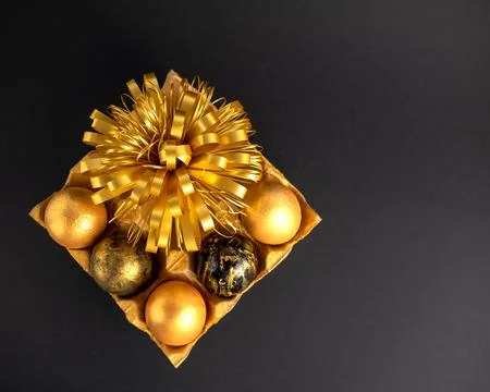 Easter eggs painted in gold and black. Lie on a textured stand with a Golde.. Stock Photos