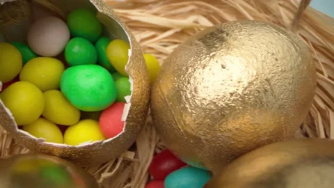 Easter eggs painted in gold color on blue wooden table close up 動画素材 146372259