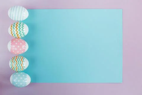 Easter eggs in pastel colors with a pattern on a pink background. Stock Photos