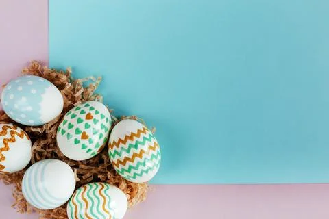Easter eggs in pastel colors with a pattern on a pink background. Stock Photos