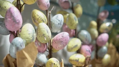 Easter eggs in pastel colors on small branches in the form of a bouquet Stock Footage 189888478