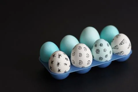 Easter eggs with pattern in blue plastic egg stand Stock Photos