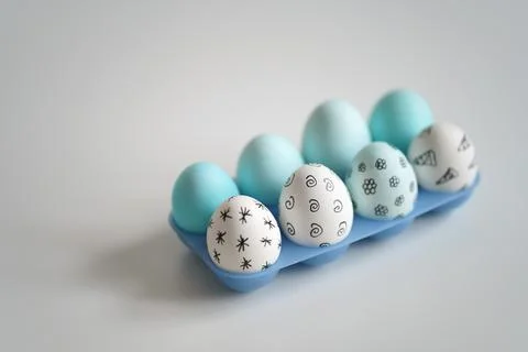 Easter eggs with pattern in blue plastic egg stand Stock Photos