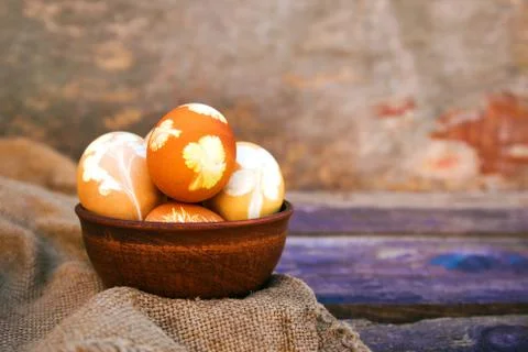 Easter eggs with pattern colored with onion peel on old wooden background. Stock Photos