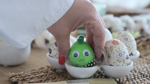 Easter eggs with a pattern in hands, female hands decorate eggs for Easter Video stock 238020796