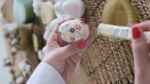 Easter eggs with a pattern in hands, female hands decorate eggs for Easter Video stock 238020926