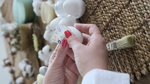 Easter eggs with a pattern in hands, female hands decorate eggs for Easter Video stock 238021273