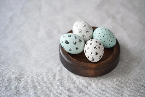 Easter eggs with patterns on wooden plate stand Stock Photos