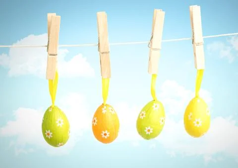 Easter Eggs on pegs in front of blue sky Stock Illustration