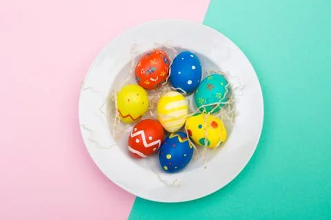 Easter eggs on plate on colour background, top view Stock Photos