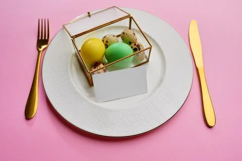 Easter eggs on plate, tableware, pink background Stock Photos