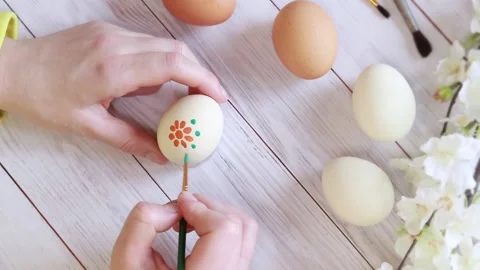 Easter eggs. Preparation for the holiday, paint eggs with paints, draw a flower Stock Footage 233167444