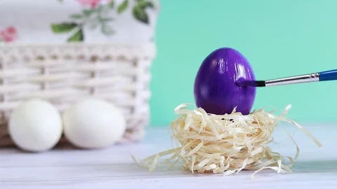 Easter eggs. Preparing for the holiday, paint the egg purple Stock Footage 233180350