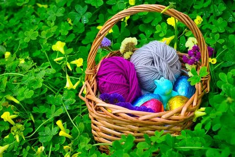 Easter eggs with a rabbit in a basket between vegetation 写真素材