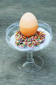 Easter eggs with rainbow chocolate ball sweet and dessert on wooden table b.. Stock Photos