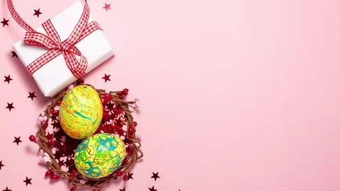 Easter eggs, red stars, and gift box with copy space Stock Footage 123808696