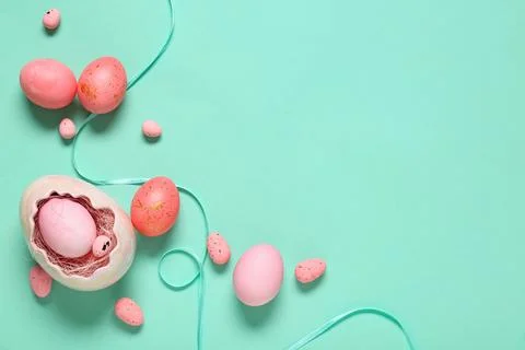 Easter eggs with ribbon on turquoise background Stock Photos