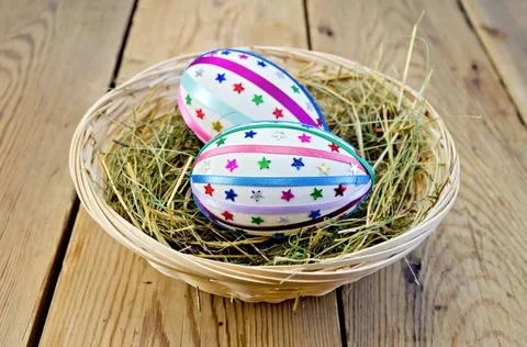 Easter eggs with ribbons and sequins in a basket Two easter eggs, decorate... 스톡 사진
