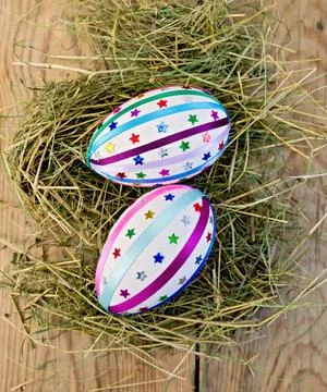 Easter eggs with ribbons and sequins on board Two easter eggs, decorated w... 스톡 사진