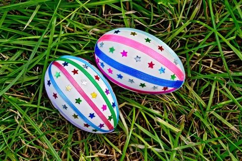 Easter eggs with ribbons and sequins on grass Two easter eggs, decorated w... 스톡 사진