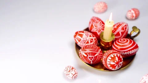 Easter eggs rolled up to candlestick and red eggs with folk pattern Stock Footage 127886918
