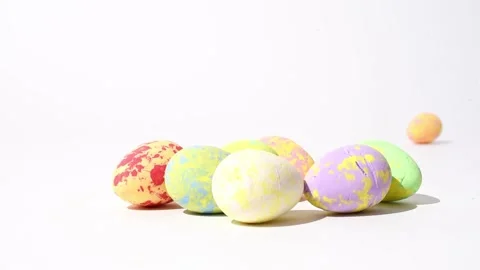 Easter eggs rolling over on white background, painted eggs easter decoration. Stock Footage 235813188