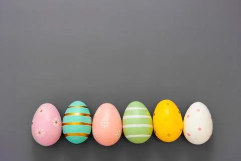 Easter eggs in row, decorative abstract colorful eggs. Over grey background,  Stock-Fotos