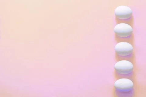 Easter eggs in a row on a pink background. Easter creative greeting card. Stock Photos