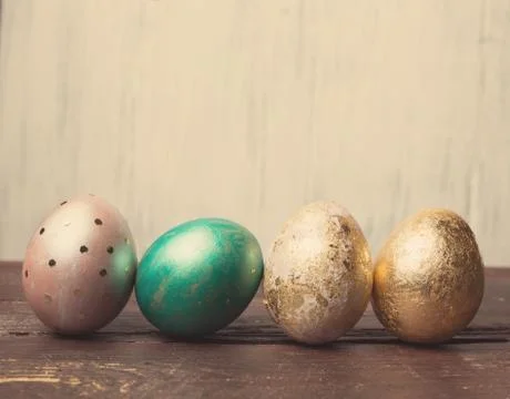 Easter eggs on rustic wooden table. Holiday background. Tinted p Stock Photos