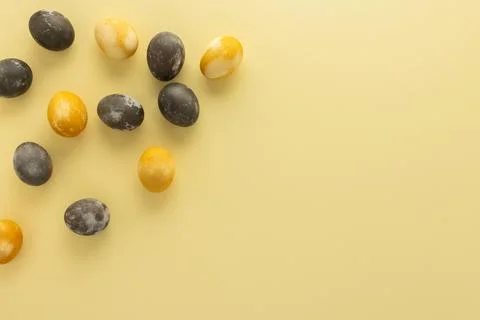 Easter eggs scattered on yellow background Stock Photos