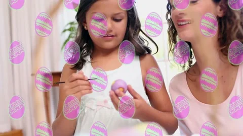 Easter eggs in seamless pattern against caucasian mother and daughter painting Stock Footage 176928874