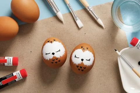 Easter eggs with sleeping owls, hand-painted with acrylics, on a background.. Stock Photos