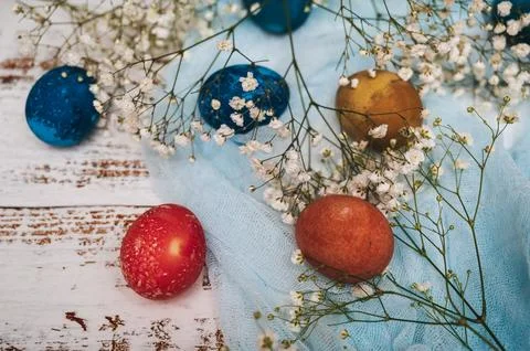 Easter eggs, small white flowers and decorations on a light background. Happy Stock Photos