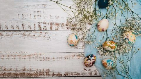 Easter eggs, small white flowers and decorations on a light background. Happy Stock Photos