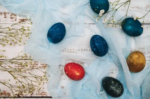 Easter eggs, small white flowers and decorations on a light background. Happy Stock Photos