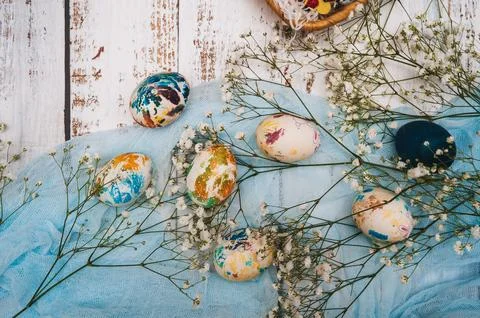 Easter eggs, small white flowers and decorations on a light background. Happy Stock Photos
