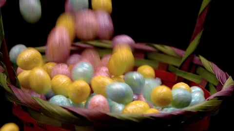 Easter eggs spill over the edge of basket Stock Footage 87692160
