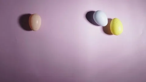 Easter eggs spinning on a pink background Stock Footage 261379056