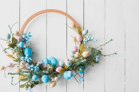 Easter Eggs Spring Background. Easter wreath on wooden white background Stock Photos