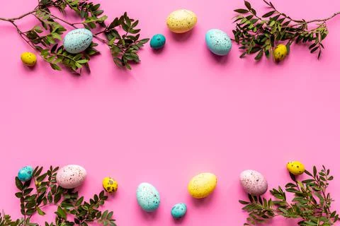 Easter eggs with spring branches and green leaves. Decoration concept, top view Stock Photos