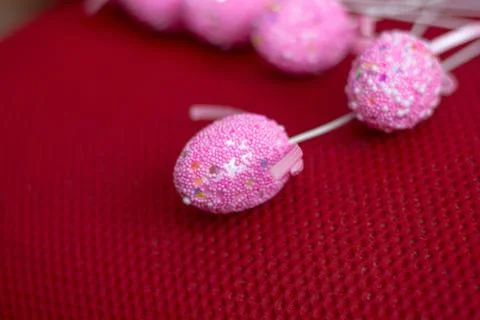Easter eggs on a sticks over the red background. Stock Photos