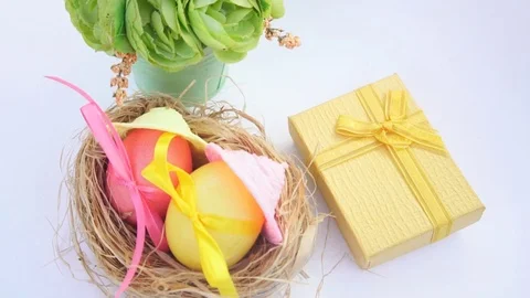 Easter Eggs in Straw Nest and Spring Flowers Stock Footage 73506188