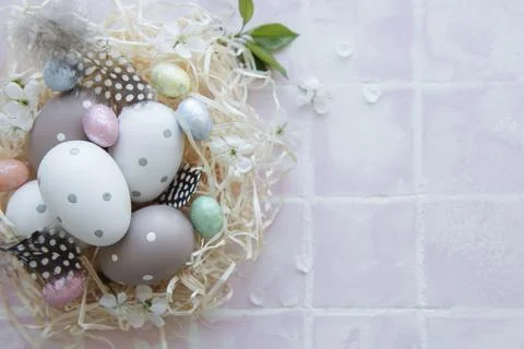 Easter eggs in straw nest Stock Photos