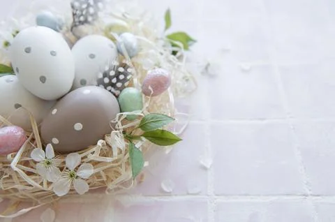 Easter eggs in straw nest Stock Photos