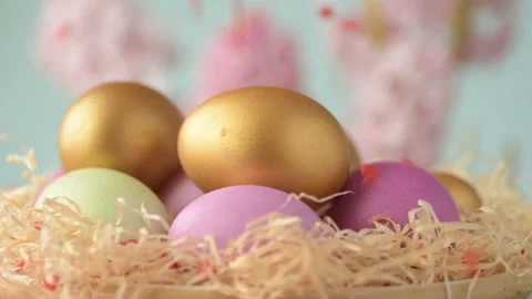 Easter eggs in straw spin on blue background Stock Footage 148287351