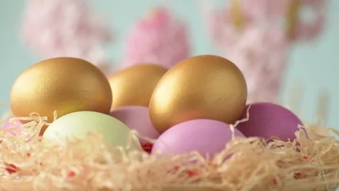 Easter eggs in straw spin on blue background Stock Footage 148287375