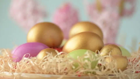Easter eggs in straw spin on blue background Stock Footage 148287390