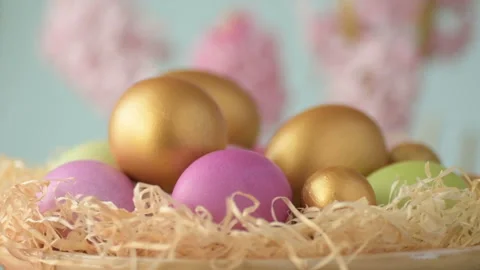 Easter eggs in straw spin on blue background Stock Footage 148287424