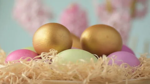 Easter eggs in straw spin on blue background Stock Footage 148287427