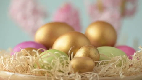 Easter eggs in straw spin on blue background Stock Footage 148287441